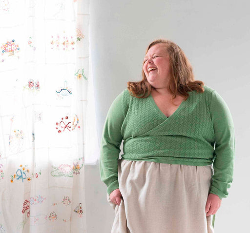 Woman in green knitwear smiling