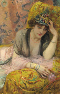 Woman in a decorative hat and jewelry, reclining on a patterned cushion.