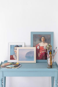 Blue Light Art Prints on a blue table with Frida Kahlo portrait