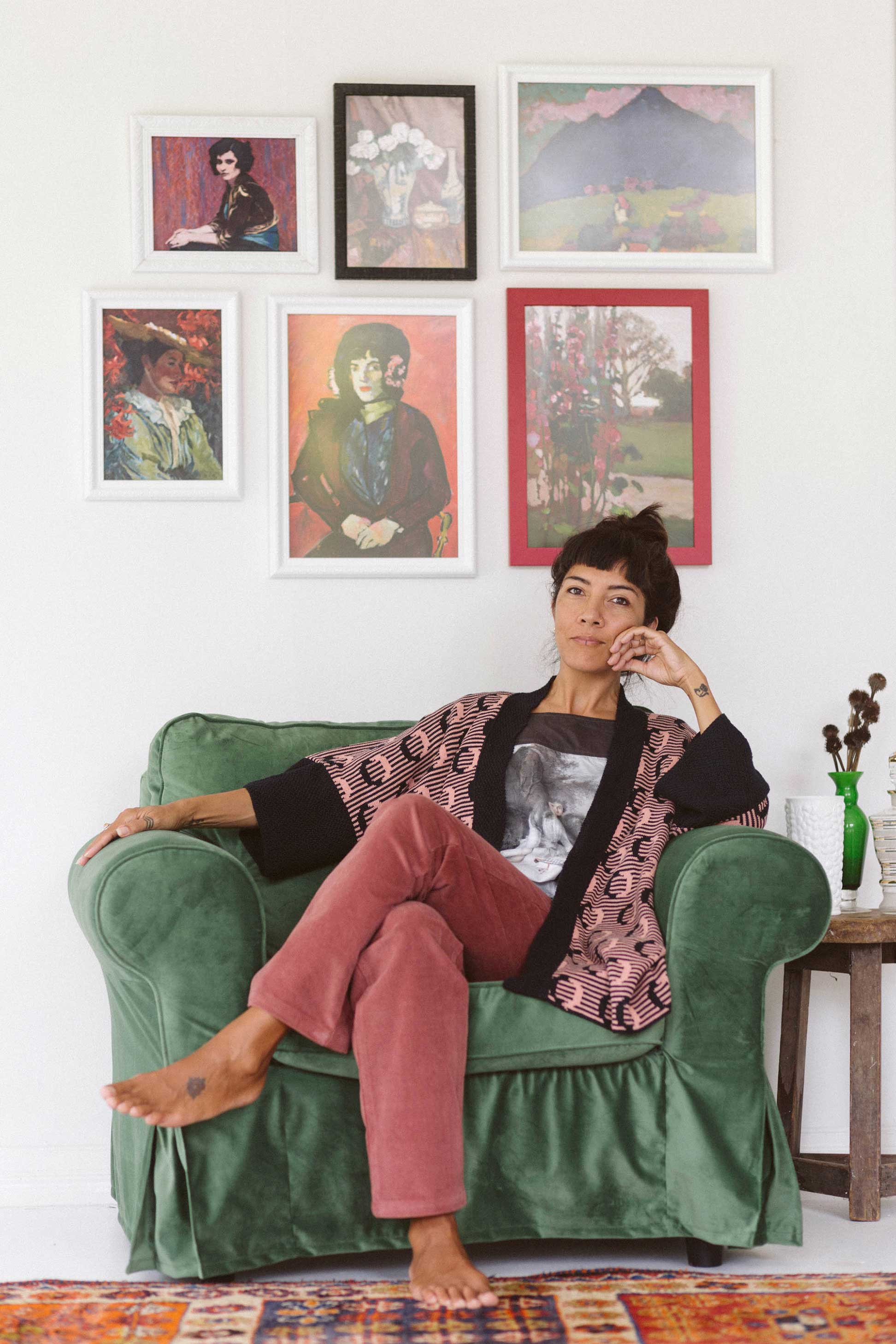 Young lady in ash rose corduroy pants with art prints.