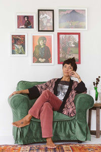 Young lady in ash rose corduroy pants with art prints.