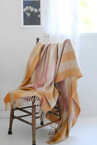 Orange gingham blanket art print with white rose on chair