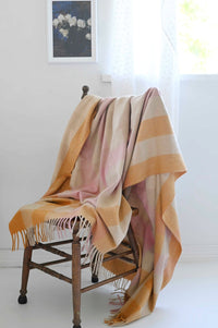 Orange gingham blanket art print with white rose on chair