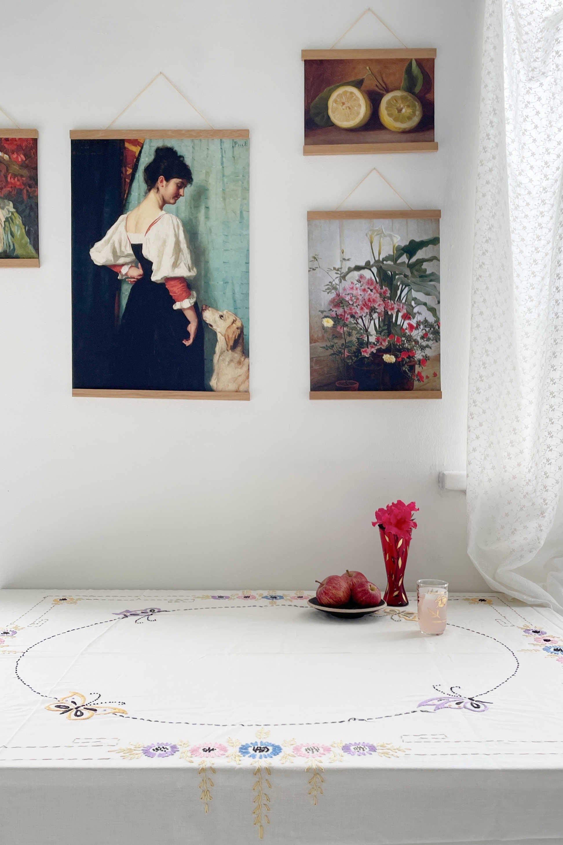 Vintage art prints on wall, woman & dog, flowers, lemons