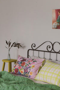 Pink floral pillowcase set on bed.