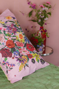 Pink floral pillowcase on green quilt