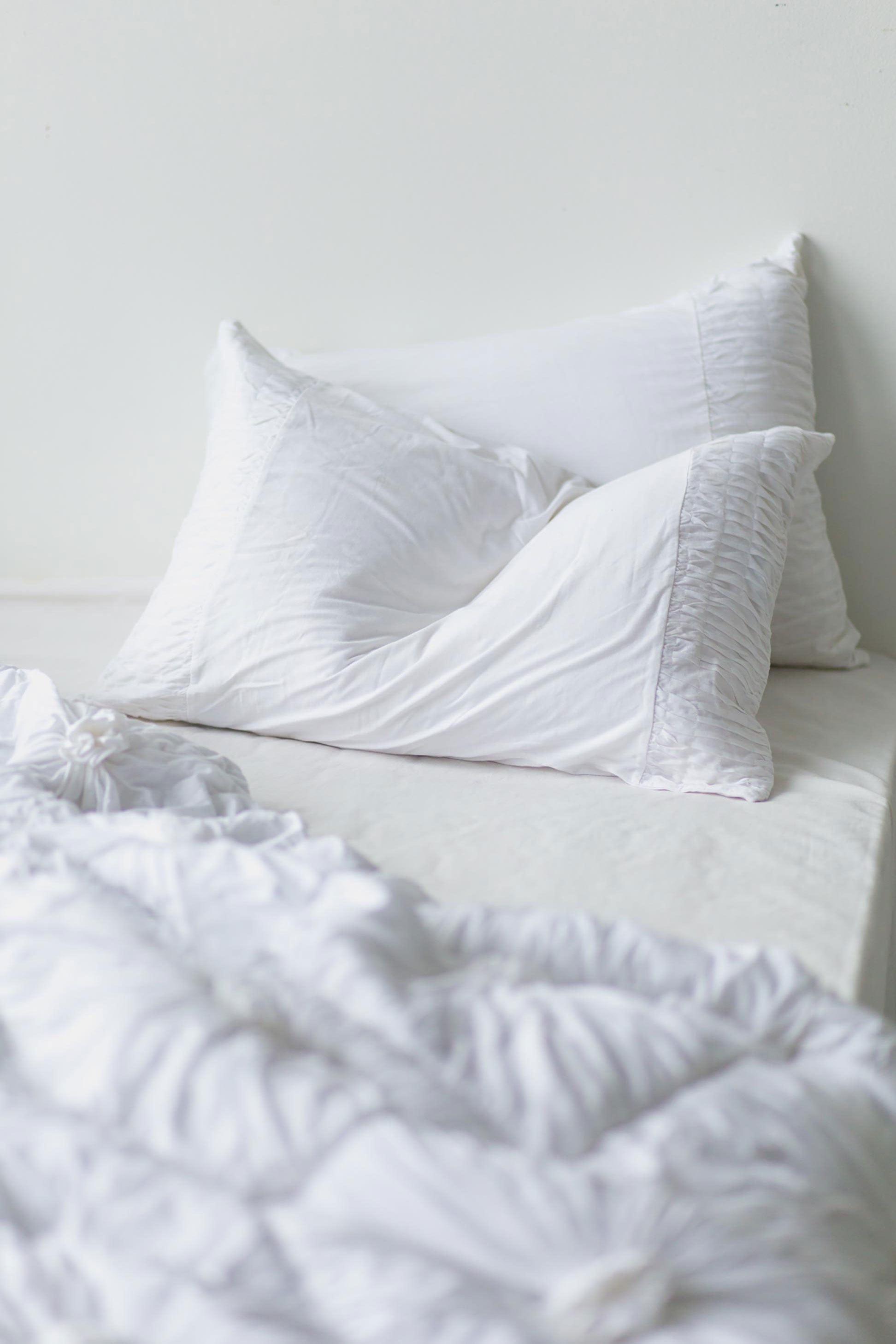 White rosette quilt pillowcase set on bed