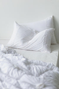 White rosette quilt pillowcase set on bed